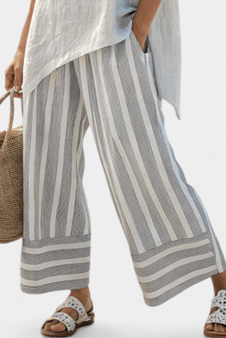 Daisy Complete with Asymmetric Blouse and Striped Trousers for a Modern and Elegant Style