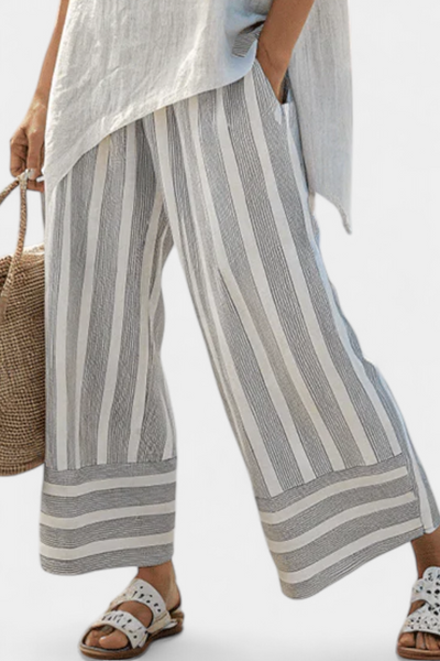 Daisy Complete with Asymmetric Blouse and Striped Trousers for a Modern and Elegant Style